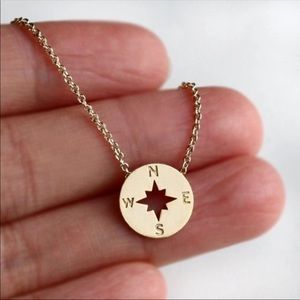 Gold tone compass necklace